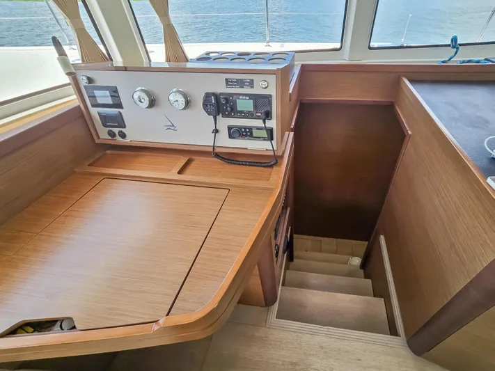 Le Tigre Yacht Photos Pics Interior of 2019 Lagoon 42 yacht with navigation panel and wooden stairs.