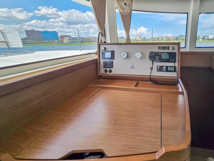 Le Tigre Yacht Photos Pics Interior view of 2019 Lagoon 42 yacht with navigation instruments and wooden finish.