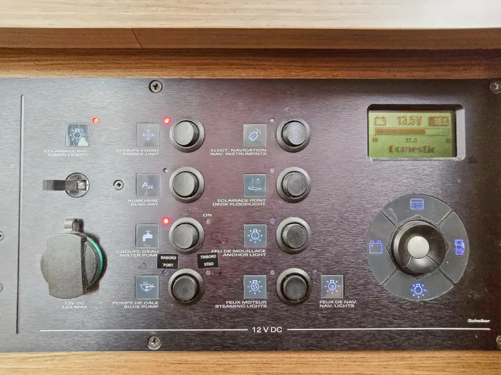 Le Tigre Yacht Photos Pics Control panel of a 2019 Lagoon 42 yacht, featuring various switches and a digital display.