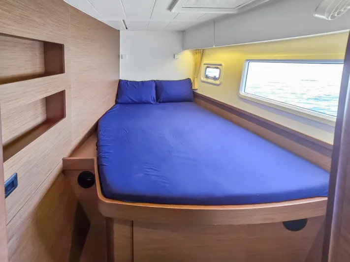 Le Tigre Yacht Photos Pics Cozy cabin interior of 2019 Lagoon 42 catamaran with blue bedding and ocean view.