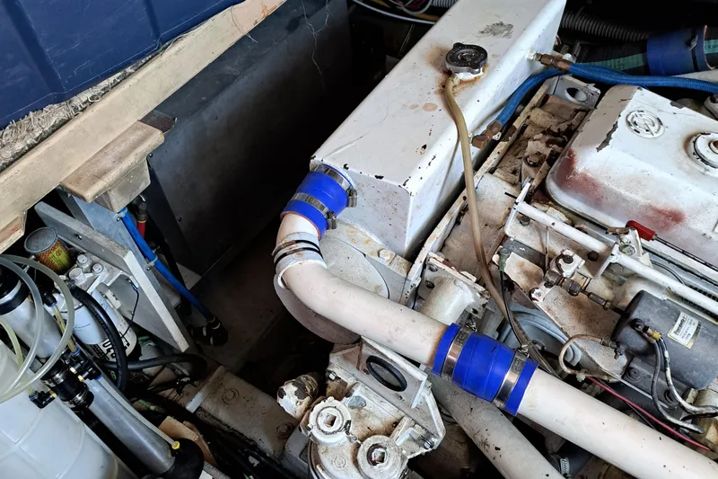 Jen & Tonic Yacht Photos Pics 1986 Post Sportfisher engine compartment with visible pipes and mechanical components.