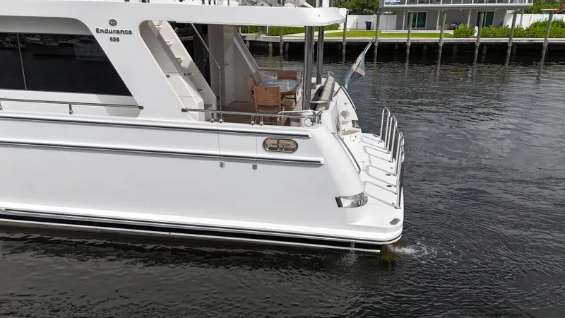 Unicorn Yacht Photos Pics 2020 Hampton 658l Endurance yacht on calm water, rear view.