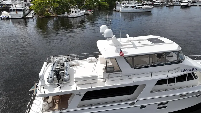 Unicorn Yacht Photos Pics 2020 Hampton 658l Endurance yacht docked in a marina, featuring a sleek design and spacious deck.