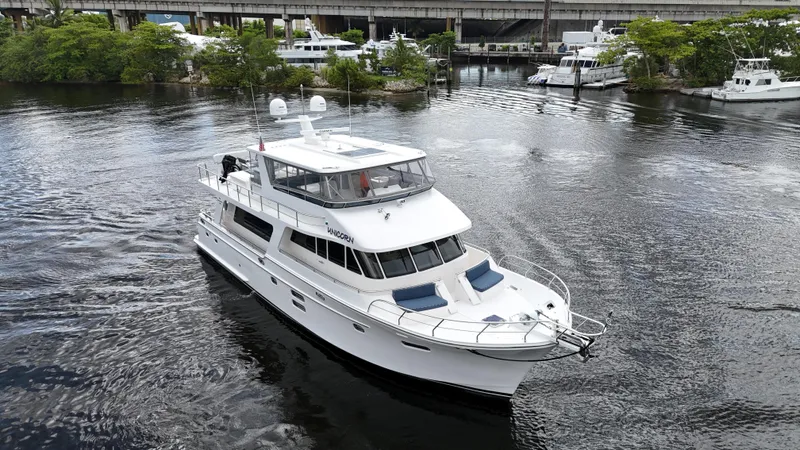 Unicorn Yacht Photos Pics 2020 Hampton 658l Endurance yacht cruising on a calm river near a marina.