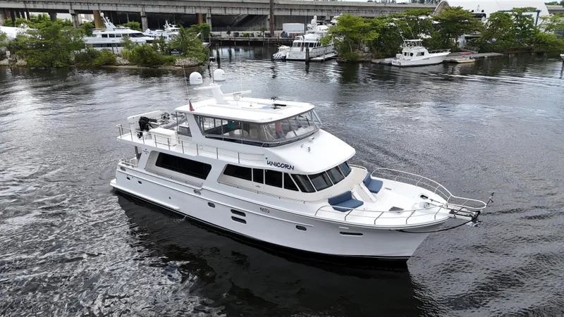 Unicorn Yacht Photos Pics 2020 Hampton 658l Endurance yacht cruising on a calm river near a marina.