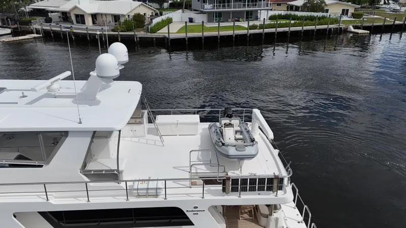 Unicorn Yacht Photos Pics Aerial view of 2020 Hampton 658l Endurance yacht docked by waterfront homes.