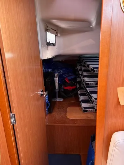 Sapphire Yacht Photos Pics Interior storage area of 2009 Beneteau Oceanis 40 sailboat with stacked items.