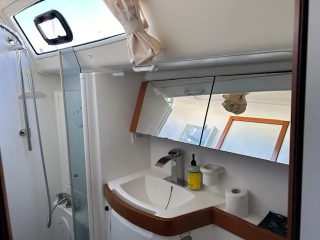 Sapphire Yacht Photos Pics Beneteau Oceanis 40 bathroom interior, featuring a modern sink and mirrored cabinets, 2009 model.