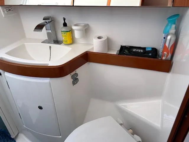 Sapphire Yacht Photos Pics Beneteau Oceanis 40 bathroom, 2009 model, featuring sink, toilet, and cleaning supplies.