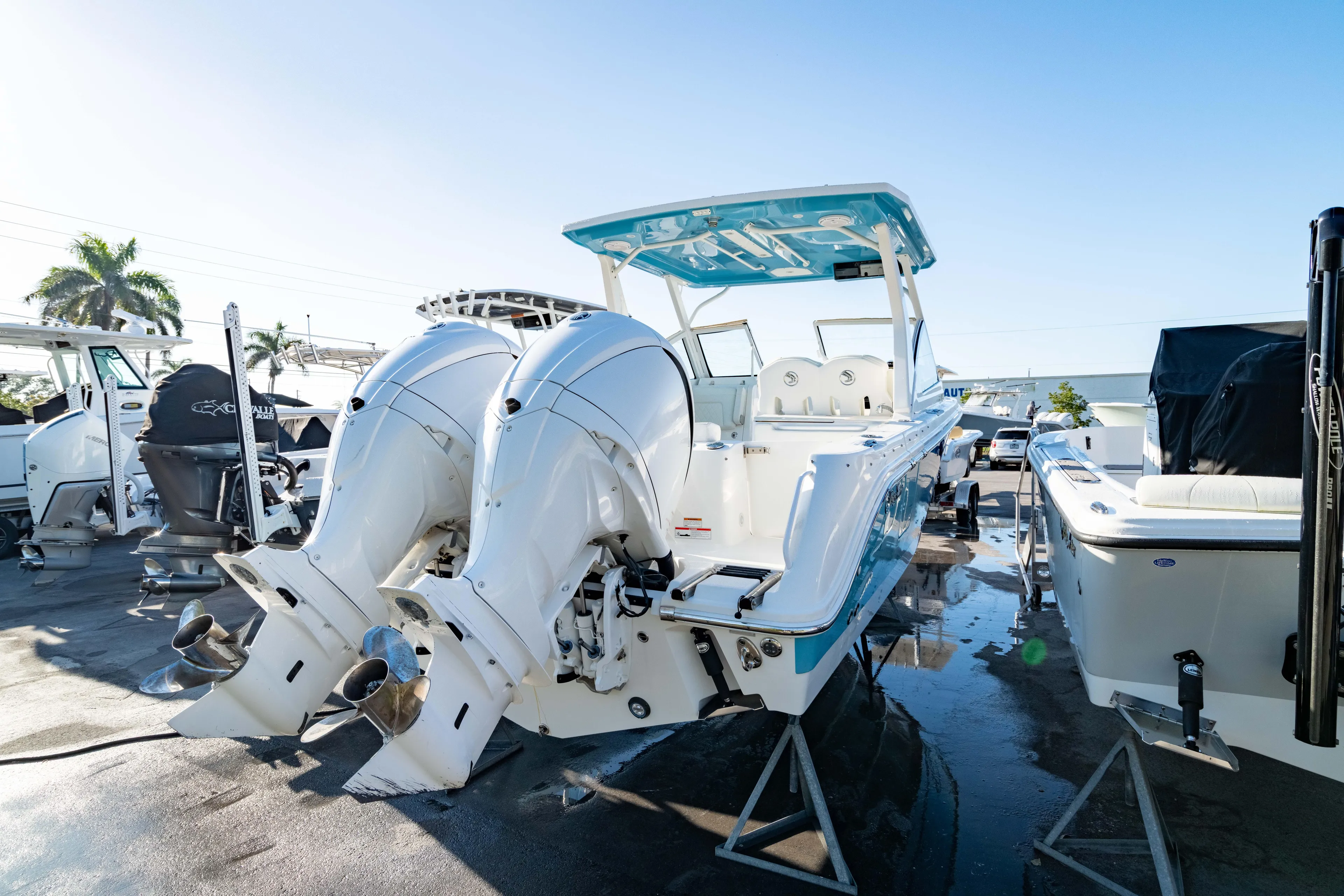  Yacht Photos Pics 2022 Edgewater 262 CX boat with dual outboard engines, displayed outdoors.
