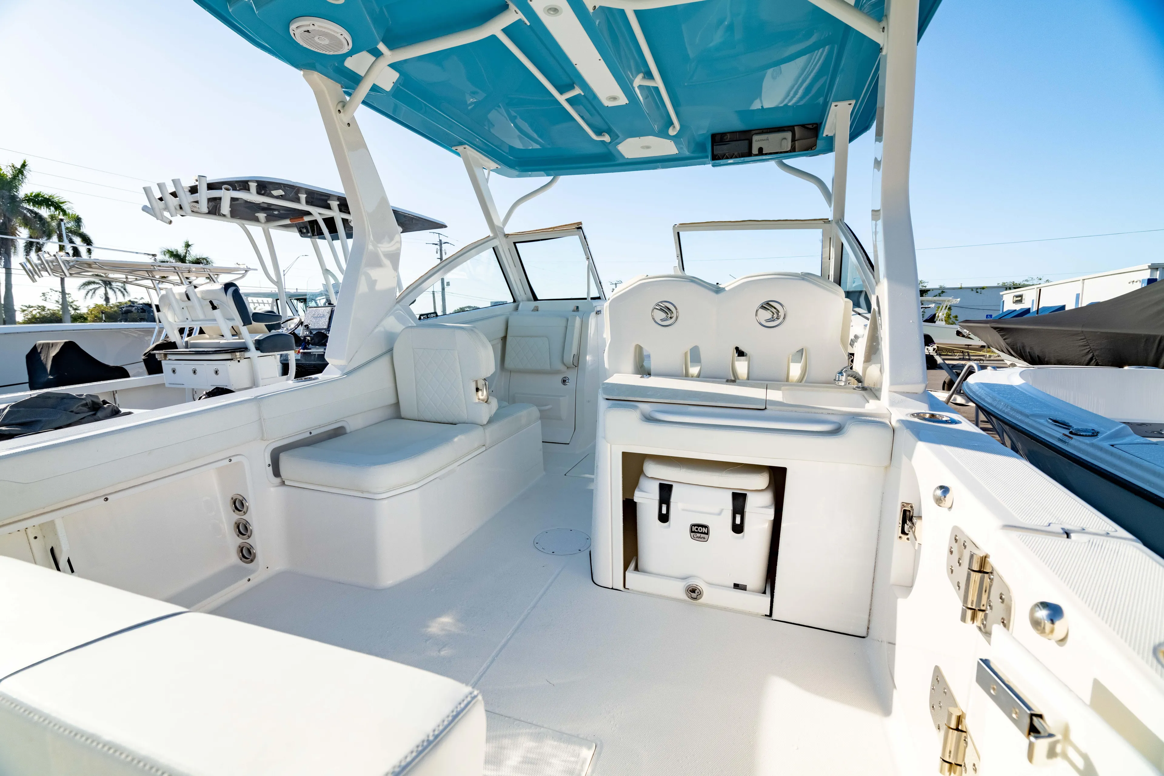  Yacht Photos Pics 2022 Edgewater 262 CX boat interior with white seating and blue canopy.