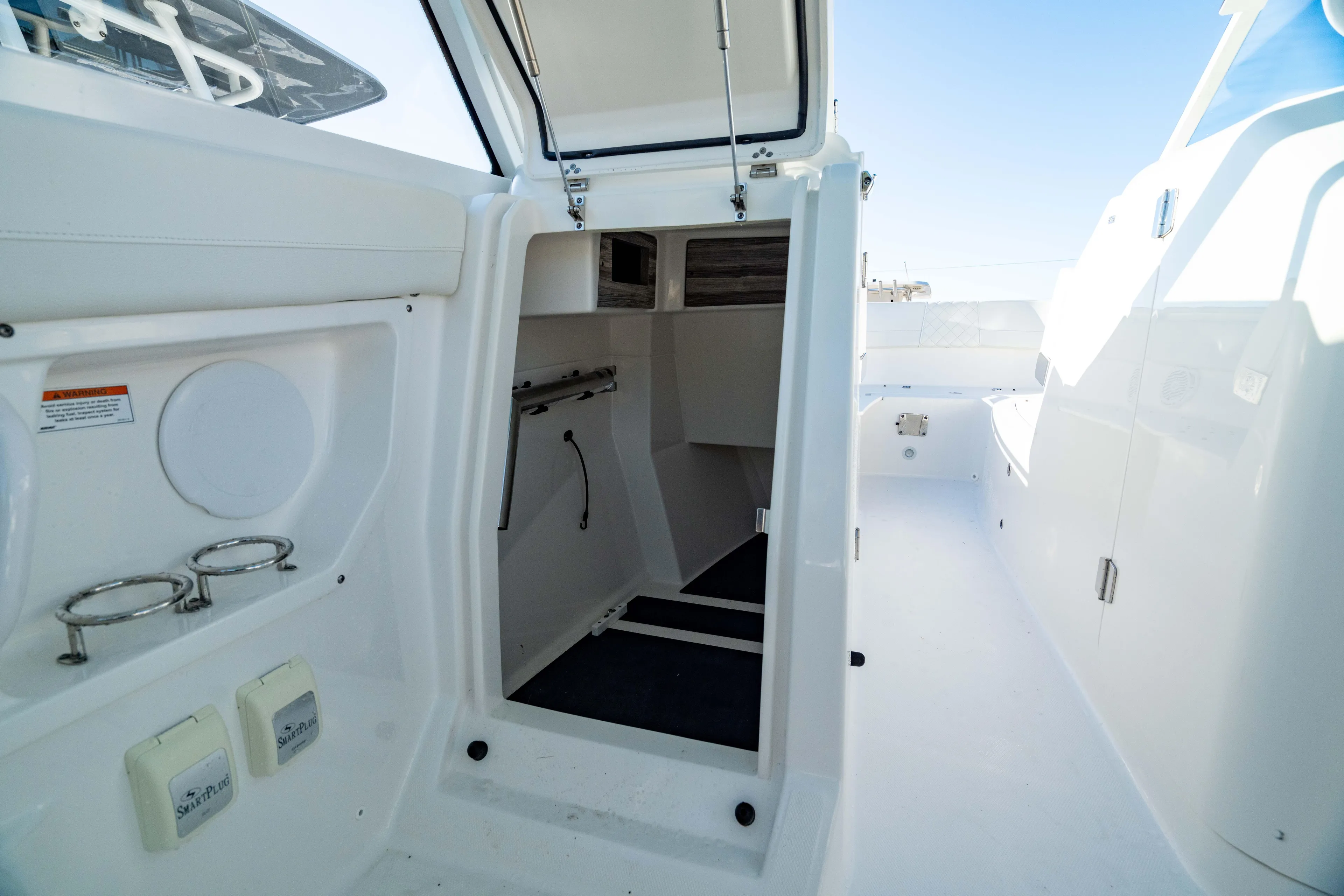  Yacht Photos Pics 2022 Edgewater 262 CX boat interior with open cabin door and storage compartments.