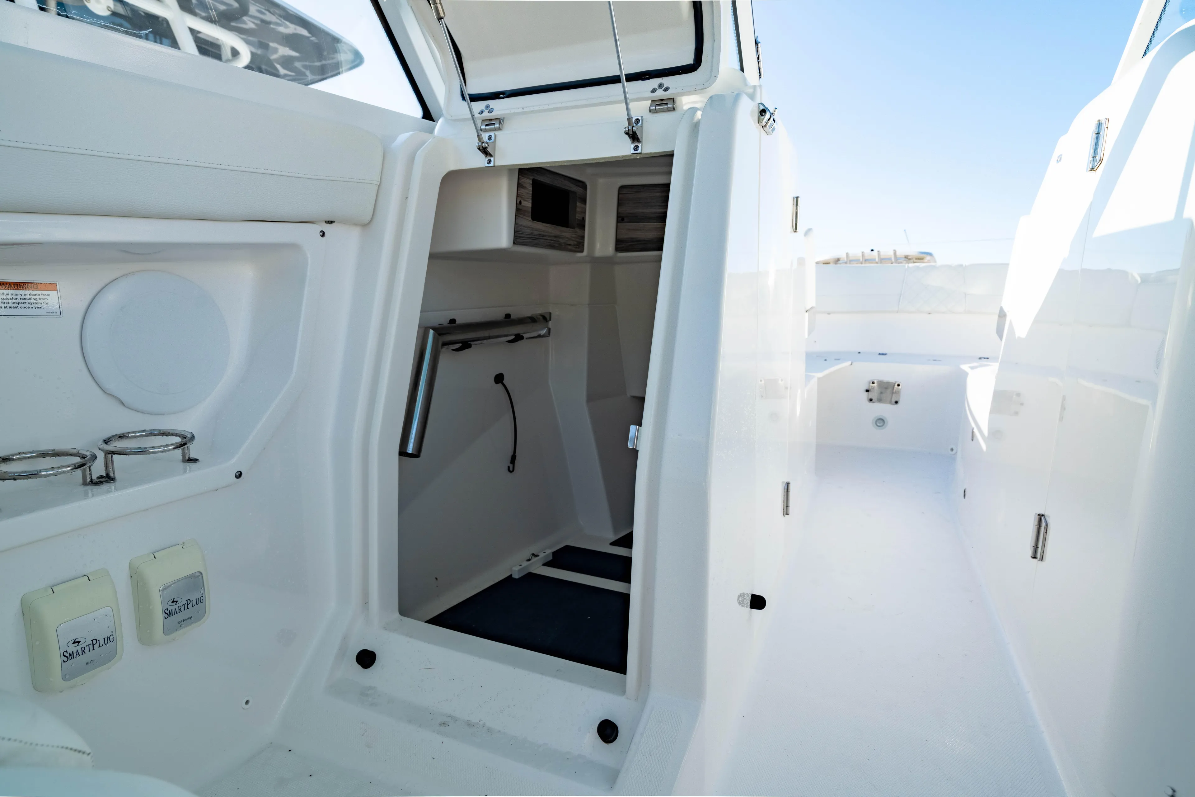  Yacht Photos Pics 2022 Edgewater 262 CX boat interior with open cabin and storage compartments.