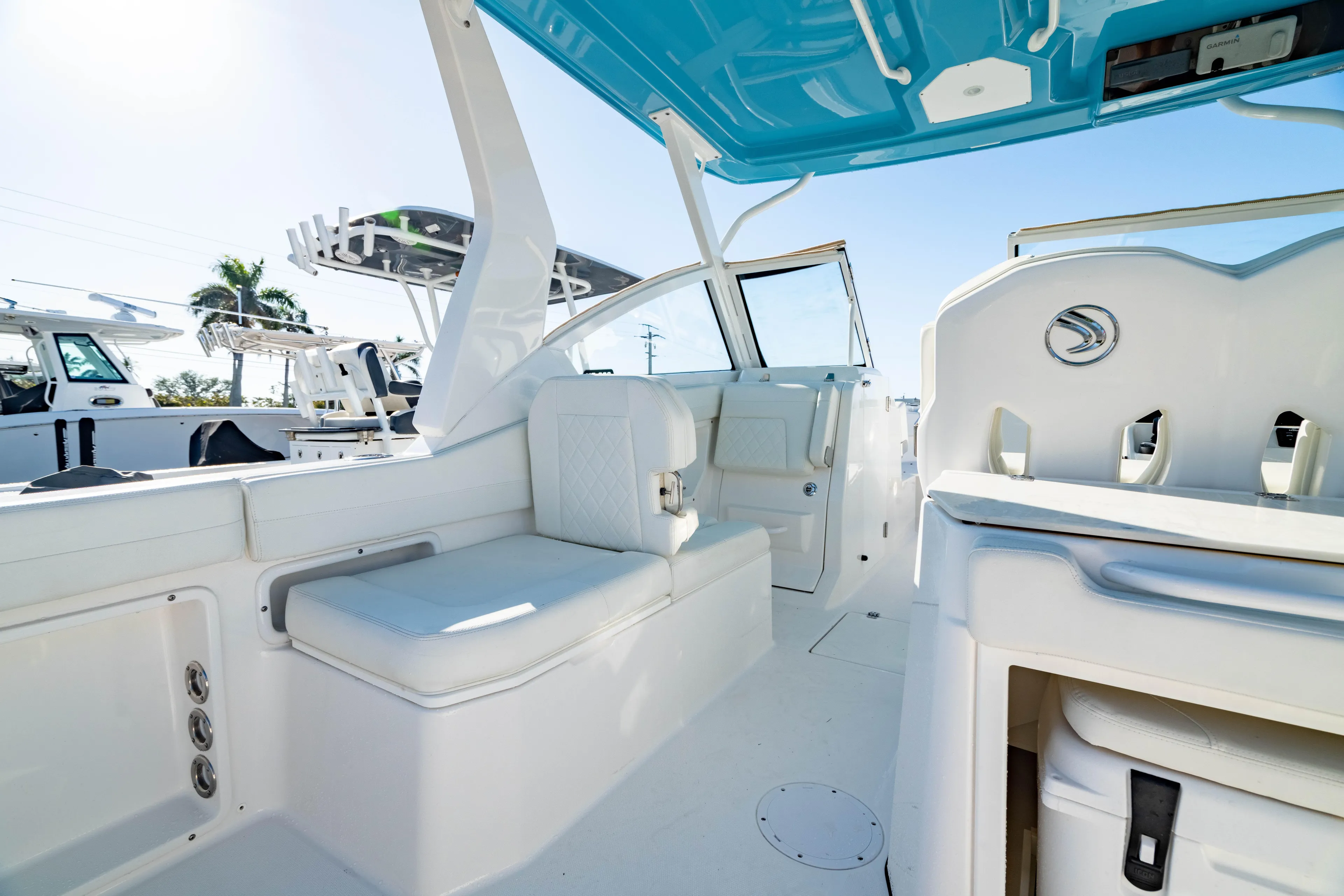  Yacht Photos Pics 2022 Edgewater 262 CX boat interior with white seating and blue canopy.