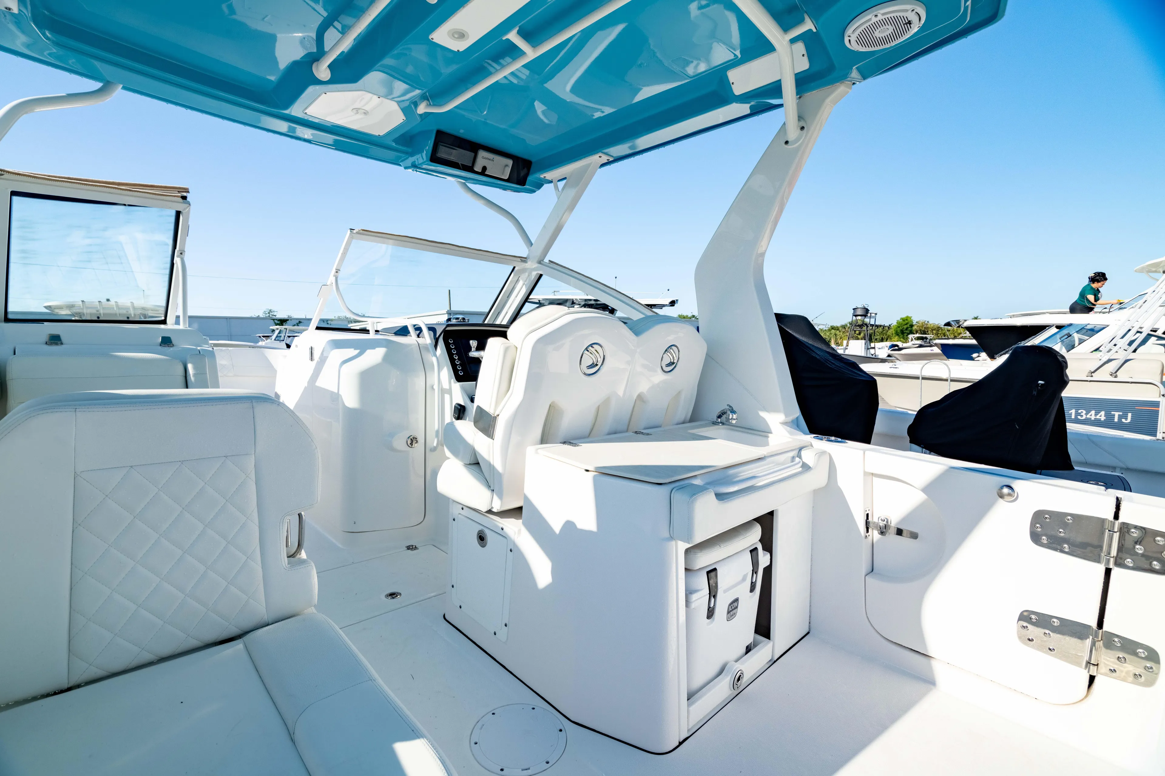  Yacht Photos Pics Interior of 2022 Edgewater 262 CX boat with white seating and blue canopy.