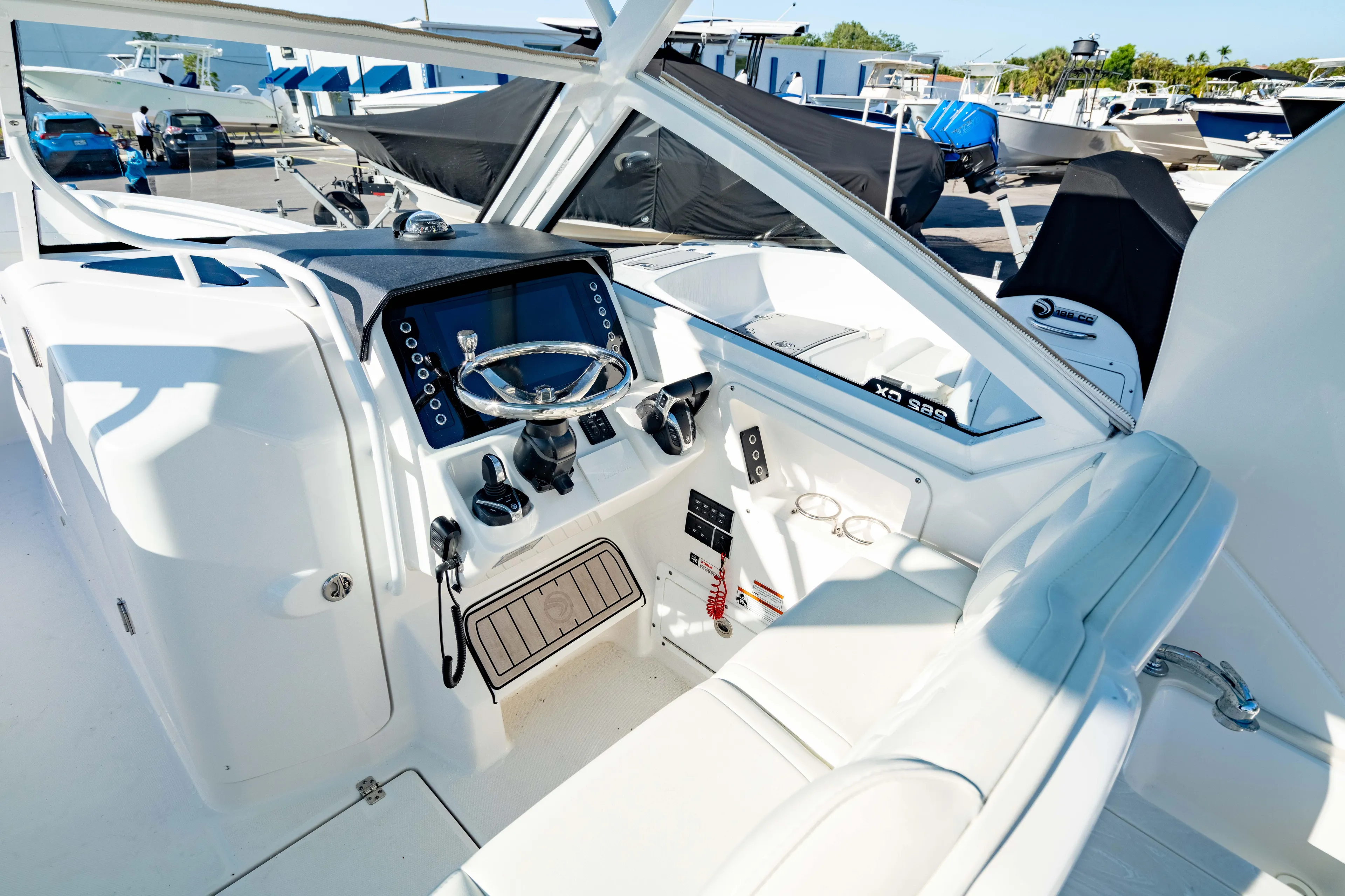  Yacht Photos Pics 2022 Edgewater 262 CX boat cockpit with modern controls and steering wheel.