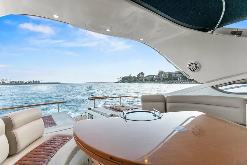 Rhapsody Yacht Photos Pics Luxurious 2004 Riva 59 Mercurius yacht interior with ocean view and elegant seating.