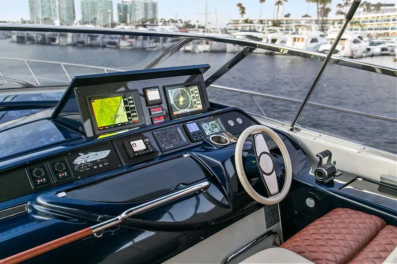 Rhapsody Yacht Photos Pics Cockpit of 2004 Riva 59 Mercurius yacht with navigation screens and steering wheel.