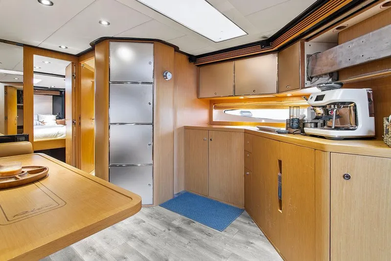 Rhapsody Yacht Photos Pics Luxurious interior of a 2004 Riva 59 Mercurius yacht with modern kitchen amenities.