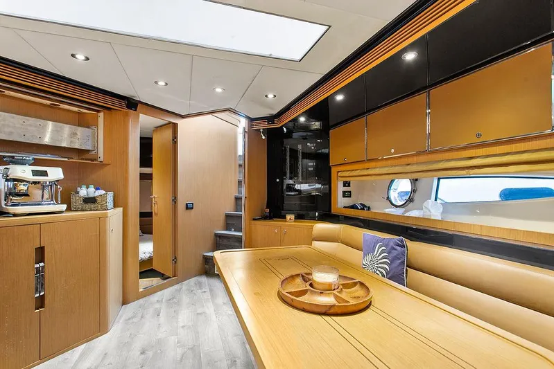 Rhapsody Yacht Photos Pics Luxurious interior of a 2004 Riva 59 Mercurius yacht with modern amenities.