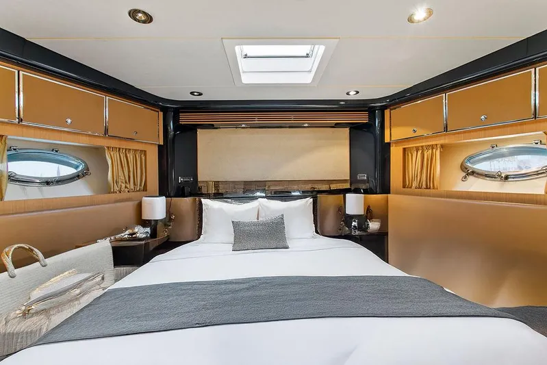 Rhapsody Yacht Photos Pics Luxurious cabin interior of 2004 Riva 59 Mercurius yacht with elegant bedding and porthole windows.