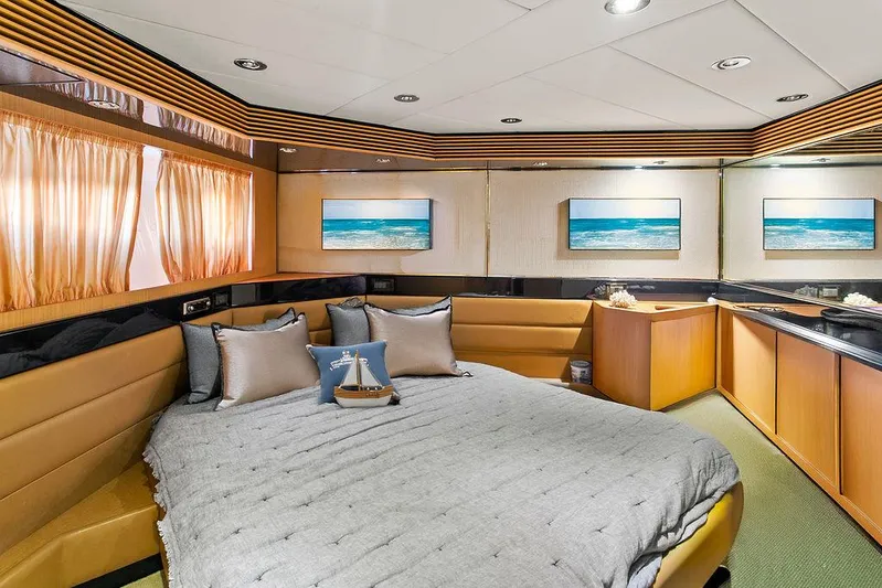 Rhapsody Yacht Photos Pics Luxurious cabin interior of 2004 Riva 59 Mercurius yacht with elegant decor and ocean-themed artwork.