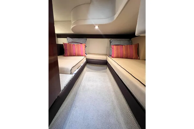 Tangerine Yacht Photos Pics 2009 Meridian 341 Sedan interior with twin beds, striped pillows, and soft lighting.