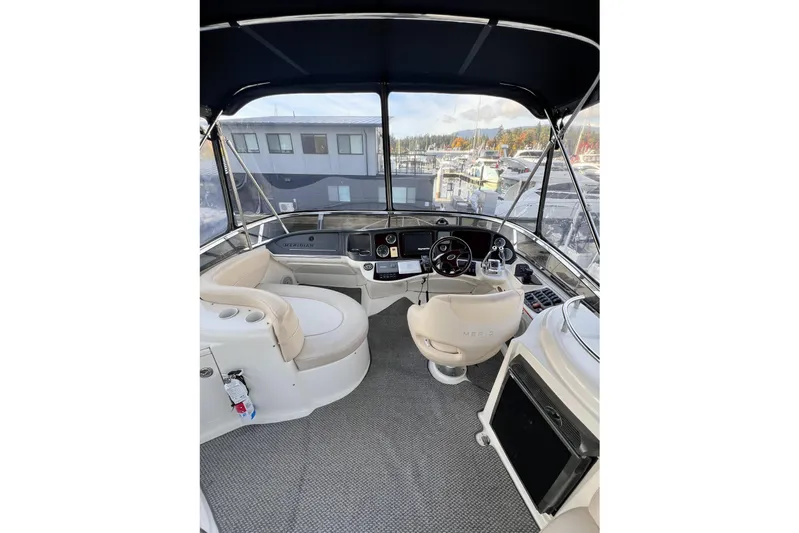 Tangerine Yacht Photos Pics 2009 Meridian 341 Sedan yacht cockpit with helm, seating, and marina view.
