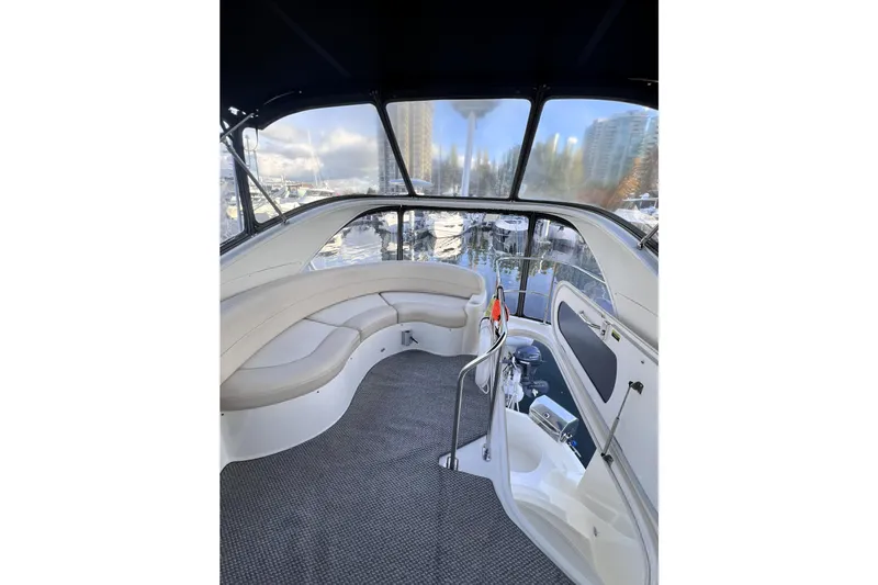 Tangerine Yacht Photos Pics Interior view of 2009 Meridian 341 Sedan yacht with seating and marina backdrop.