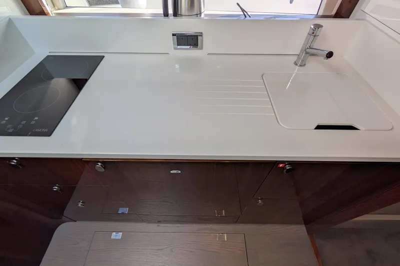 Seakeeper Gyro Yacht Photos Pics Modern kitchen area in 2022 Fairline Targa 45 GT yacht with sleek countertop and stove.