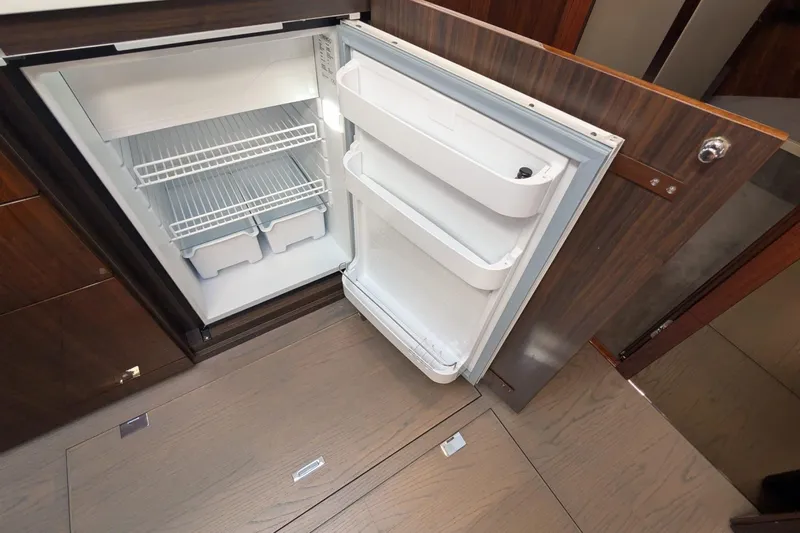 Seakeeper Gyro Yacht Photos Pics Open refrigerator inside 2022 Fairline Targa 45 GT yacht, showcasing interior shelving.