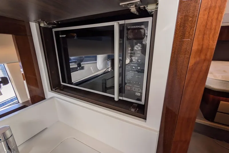 Seakeeper Gyro Yacht Photos Pics Microwave in 2022 Fairline Targa 45 GT yacht kitchen, featuring sleek wood cabinetry.