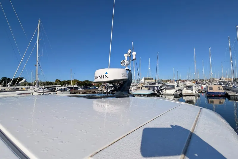 Seakeeper Gyro Yacht Photos Pics 2022 Fairline Targa 45 GT yacht with Garmin radar in a marina under clear blue sky.