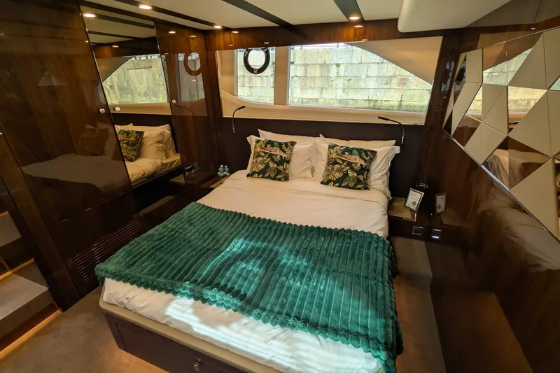 Seakeeper Gyro Yacht Photos Pics Luxurious bedroom interior of 2022 Fairline Targa 45 GT yacht with elegant decor.