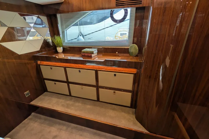 Seakeeper Gyro Yacht Photos Pics Luxurious interior of 2022 Fairline Targa 45 GT yacht with wood finish and storage drawers.