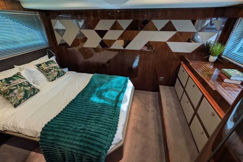 Seakeeper Gyro Yacht Photos Pics Luxurious bedroom interior of 2022 Fairline Targa 45 GT yacht with modern decor and plush bedding.