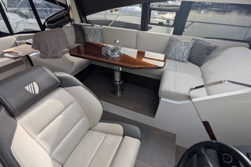 Seakeeper Gyro Yacht Photos Pics Luxurious interior of 2022 Fairline Targa 45 GT yacht with elegant seating and table.