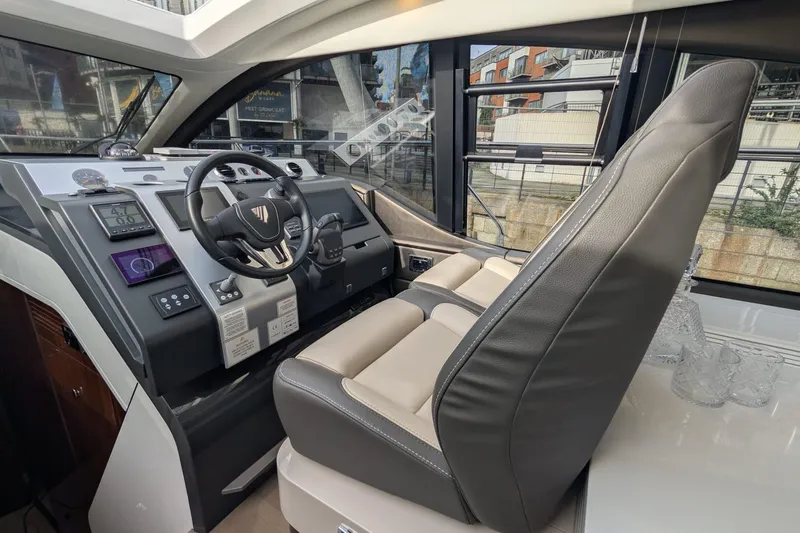 Seakeeper Gyro Yacht Photos Pics Interior cockpit of 2022 Fairline Targa 45 GT yacht with modern controls and leather seating.