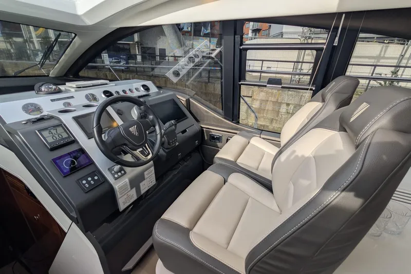 Seakeeper Gyro Yacht Photos Pics Interior cockpit of 2022 Fairline Targa 45 GT yacht with modern controls and seating.