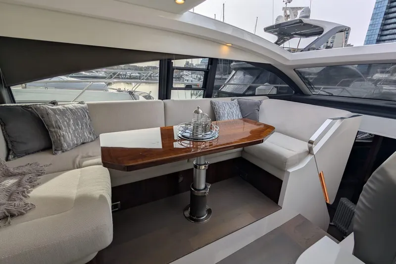 Seakeeper Gyro Yacht Photos Pics Luxurious interior of 2022 Fairline Targa 45 GT yacht with elegant seating and wooden table.
