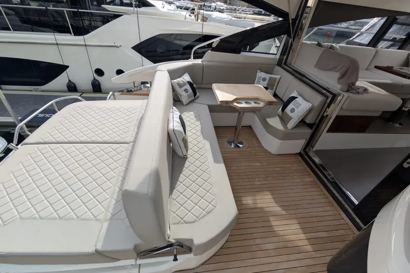 Seakeeper Gyro Yacht Photos Pics Luxurious 2022 Fairline Targa 45 GT yacht interior with elegant seating and wooden flooring.