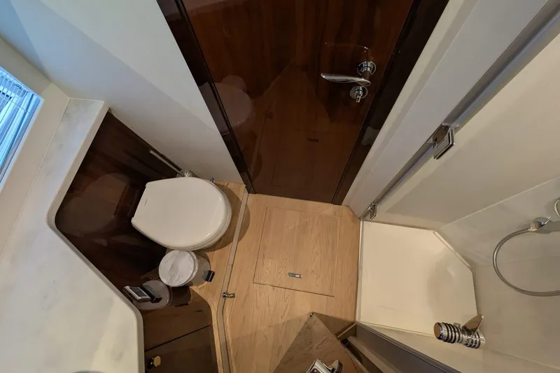 Seakeeper Gyro Yacht Photos Pics Luxurious bathroom interior of 2022 Fairline Targa 45 GT yacht, featuring modern fixtures and wood accents.