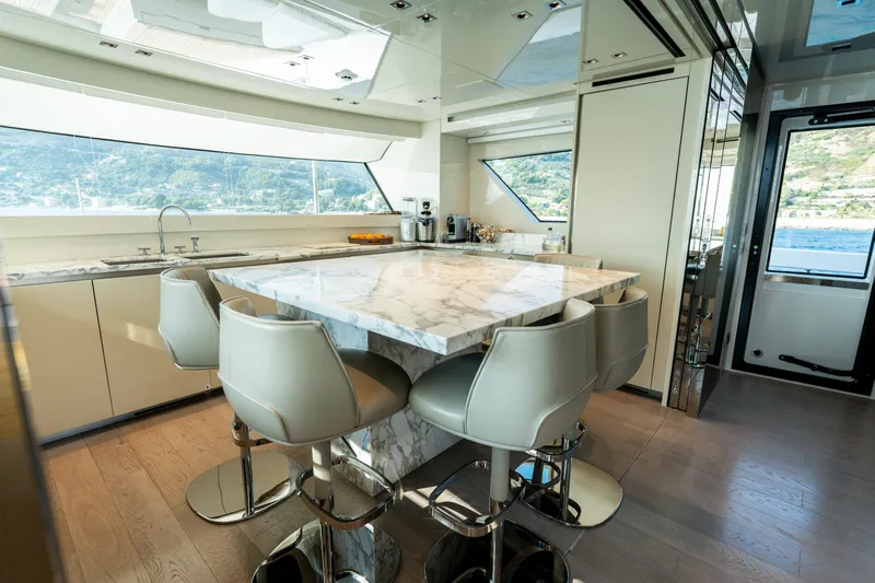 La Yacht Photos Pics Luxurious interior of 2022 Sanlorenzo SX88 yacht with marble dining area and scenic views.