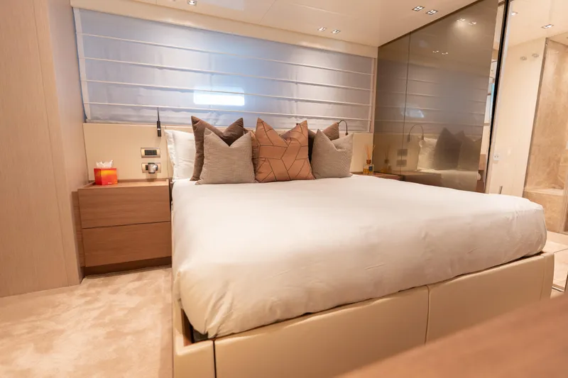 La Yacht Photos Pics Luxurious bedroom interior of 2022 Sanlorenzo SX88 yacht with modern decor and plush bedding.