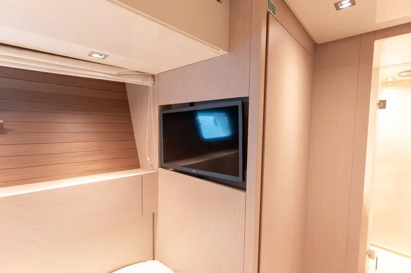 La Yacht Photos Pics Luxurious interior of 2022 Sanlorenzo SX88 yacht with modern TV and wood paneling.
