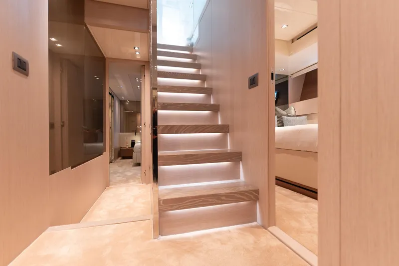La Yacht Photos Pics Luxurious interior of 2022 Sanlorenzo SX88 yacht with modern staircase and elegant design.