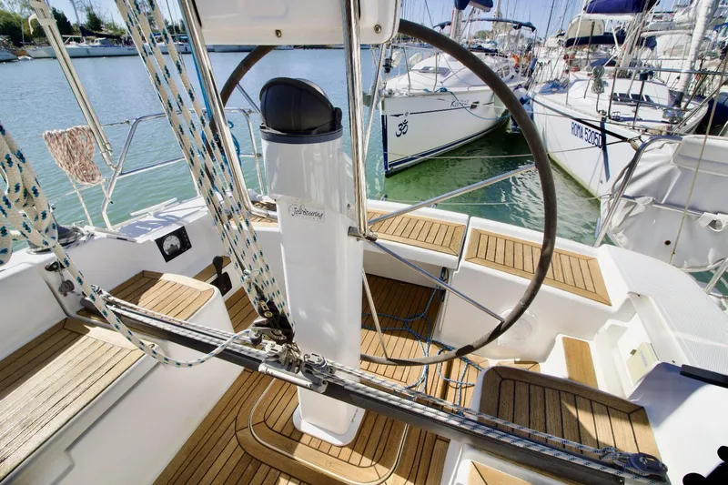  Yacht Photos Pics 2008 Hanse 370e sailboat cockpit with wooden flooring and steering wheel, docked at marina.