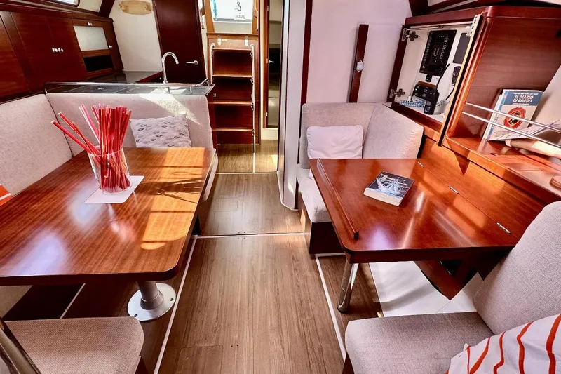  Yacht Photos Pics Interior of 2008 Hanse 370e yacht with wooden tables and cozy seating.