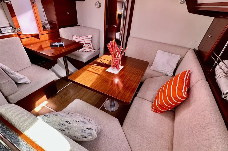  Yacht Photos Pics Interior of 2008 Hanse 370e yacht with cozy seating and wooden table.