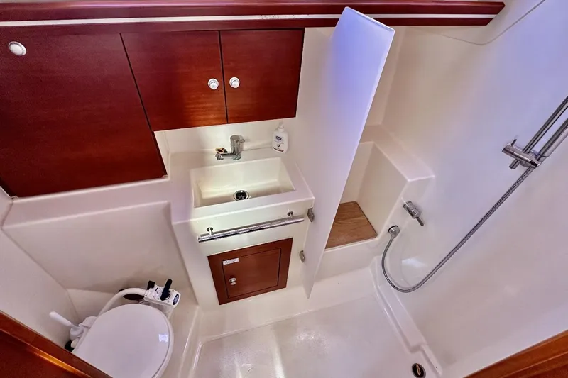  Yacht Photos Pics Interior of 2008 Hanse 370e yacht bathroom with sink, shower, and wooden cabinets.